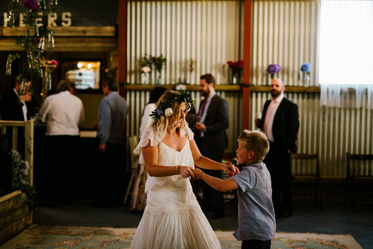 Kirsty wore a Rue de Seine gown from Leonie C. Bridal boutique in Brighton. Her handmade, Summer wedding took place in a Game of Thrones venue in Downpatrick. It was filled with floral chandeliers. Photography by Honey and the Moon.