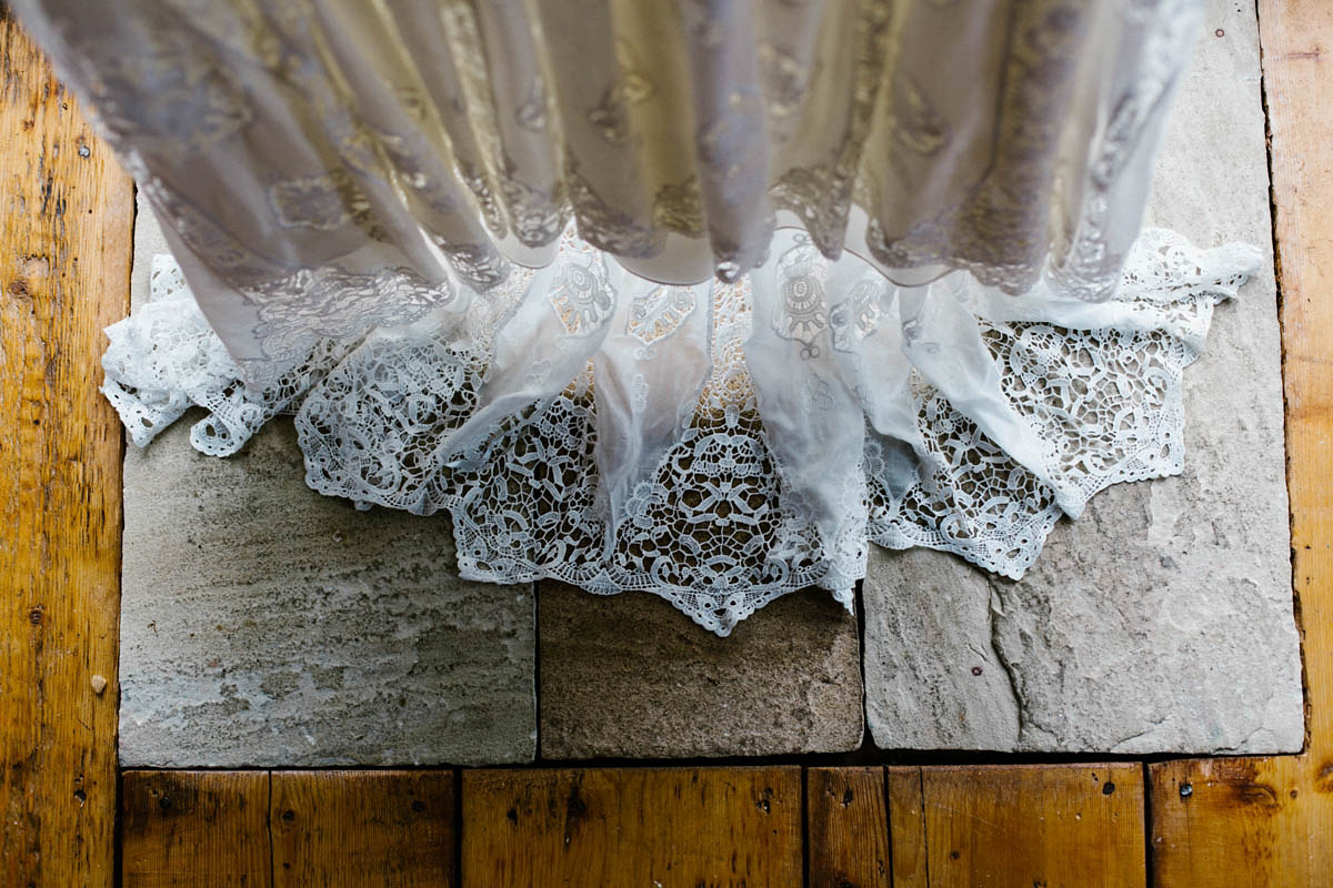 Kirsty wore a Rue de Seine gown from Leonie C. Bridal boutique in Brighton. Her handmade, Summer wedding took place in a Game of Thrones venue in Downpatrick. It was filled with floral chandeliers. Photography by Honey and the Moon.