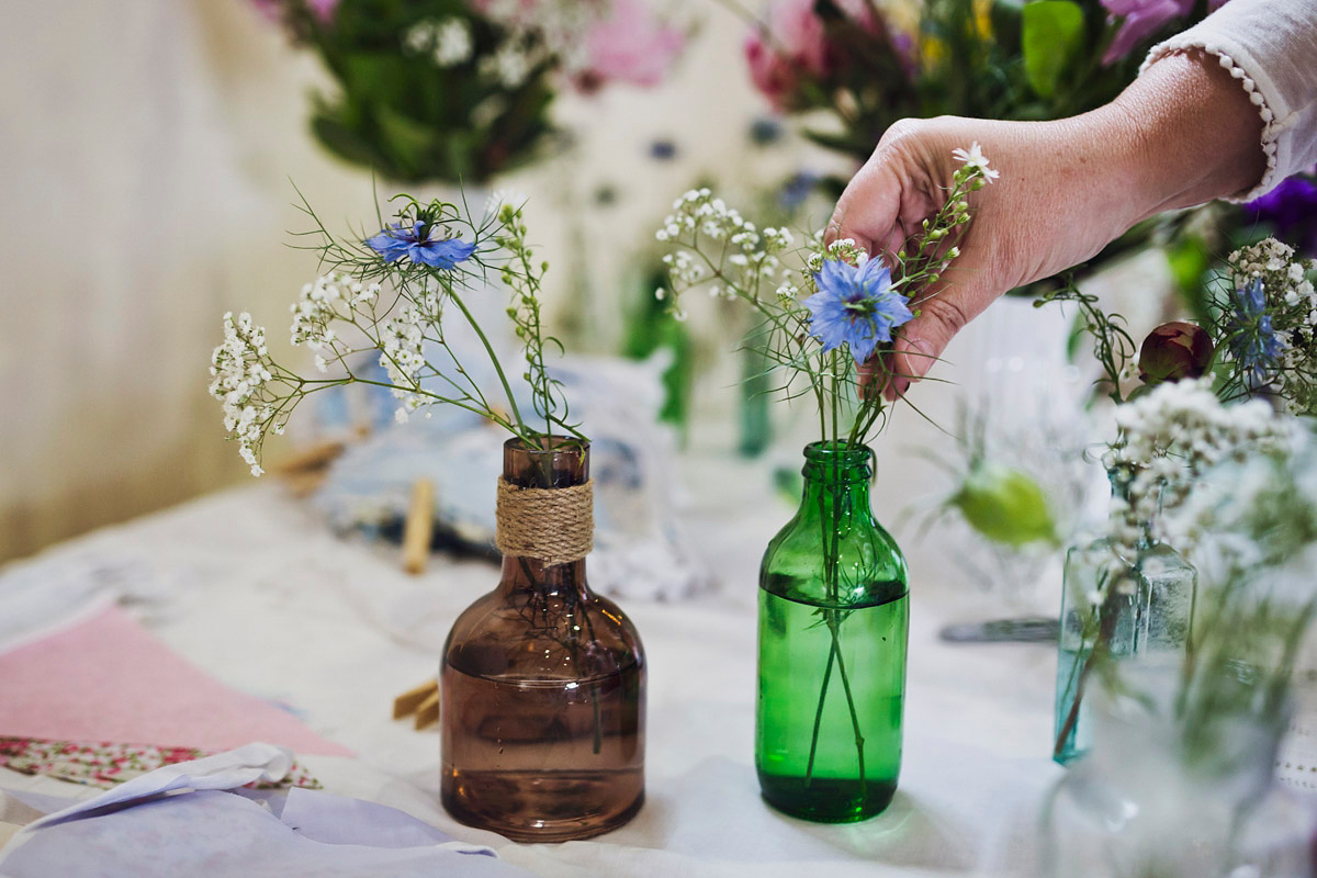 Etsy illustrator Kerris wore an ASOS wedding dress for her boho and handmade village hall wedding. We love the comic book confetti! Photography by Mark Tattersall.