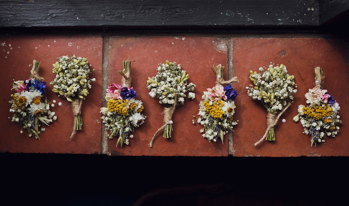 Etsy illustrator Kerris wore an ASOS wedding dress for her boho and handmade village hall wedding. We love the comic book confetti! Photography by Mark Tattersall.