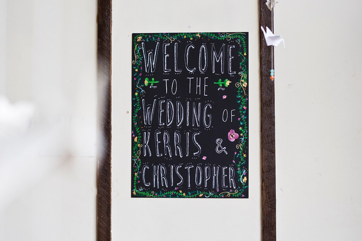 Etsy illustrator Kerris wore an ASOS wedding dress for her boho and handmade village hall wedding. We love the comic book confetti! Photography by Mark Tattersall.