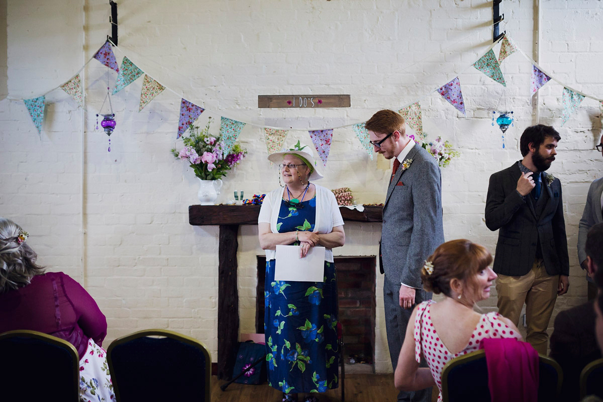 Etsy illustrator Kerris wore an ASOS wedding dress for her boho and handmade village hall wedding. We love the comic book confetti! Photography by Mark Tattersall.