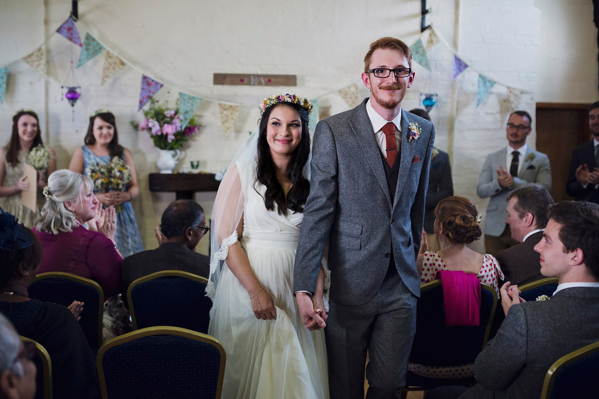 Etsy illustrator Kerris wore an ASOS wedding dress for her boho and handmade village hall wedding. We love the comic book confetti! Photography by Mark Tattersall.