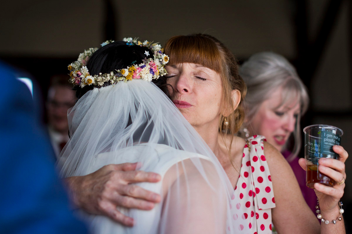 Etsy illustrator Kerris wore an ASOS wedding dress for her boho and handmade village hall wedding. We love the comic book confetti! Photography by Mark Tattersall.