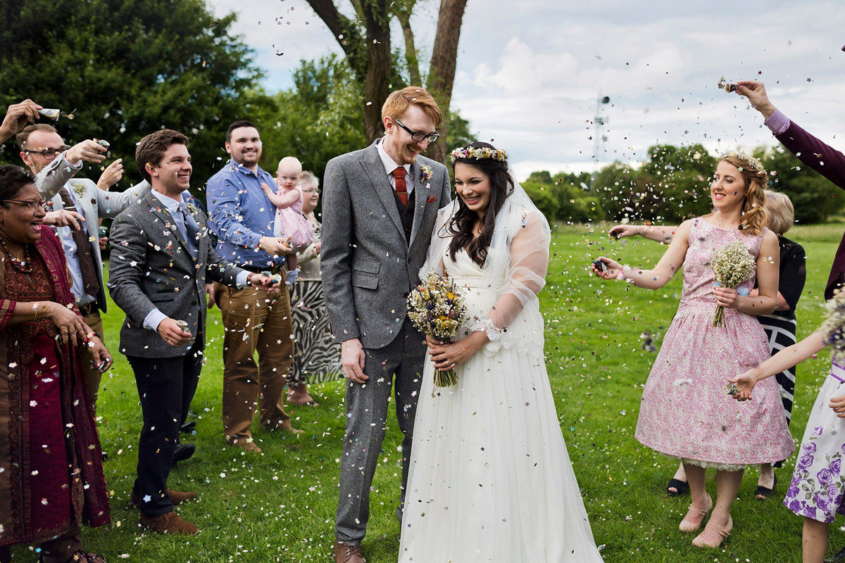 Etsy illustrator Kerris wore an ASOS wedding dress for her boho and handmade village hall wedding. We love the comic book confetti! Photography by Mark Tattersall.