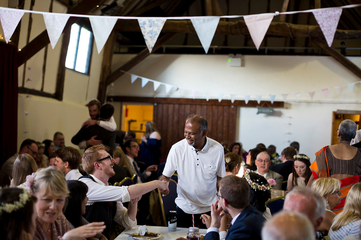 Etsy illustrator Kerris wore an ASOS wedding dress for her boho and handmade village hall wedding. We love the comic book confetti! Photography by Mark Tattersall.