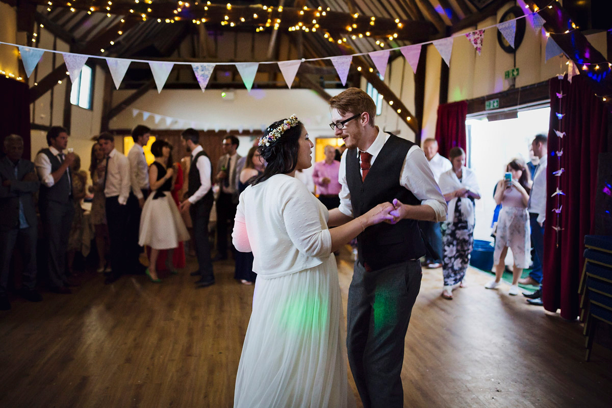 Etsy illustrator Kerris wore an ASOS wedding dress for her boho and handmade village hall wedding. We love the comic book confetti! Photography by Mark Tattersall.