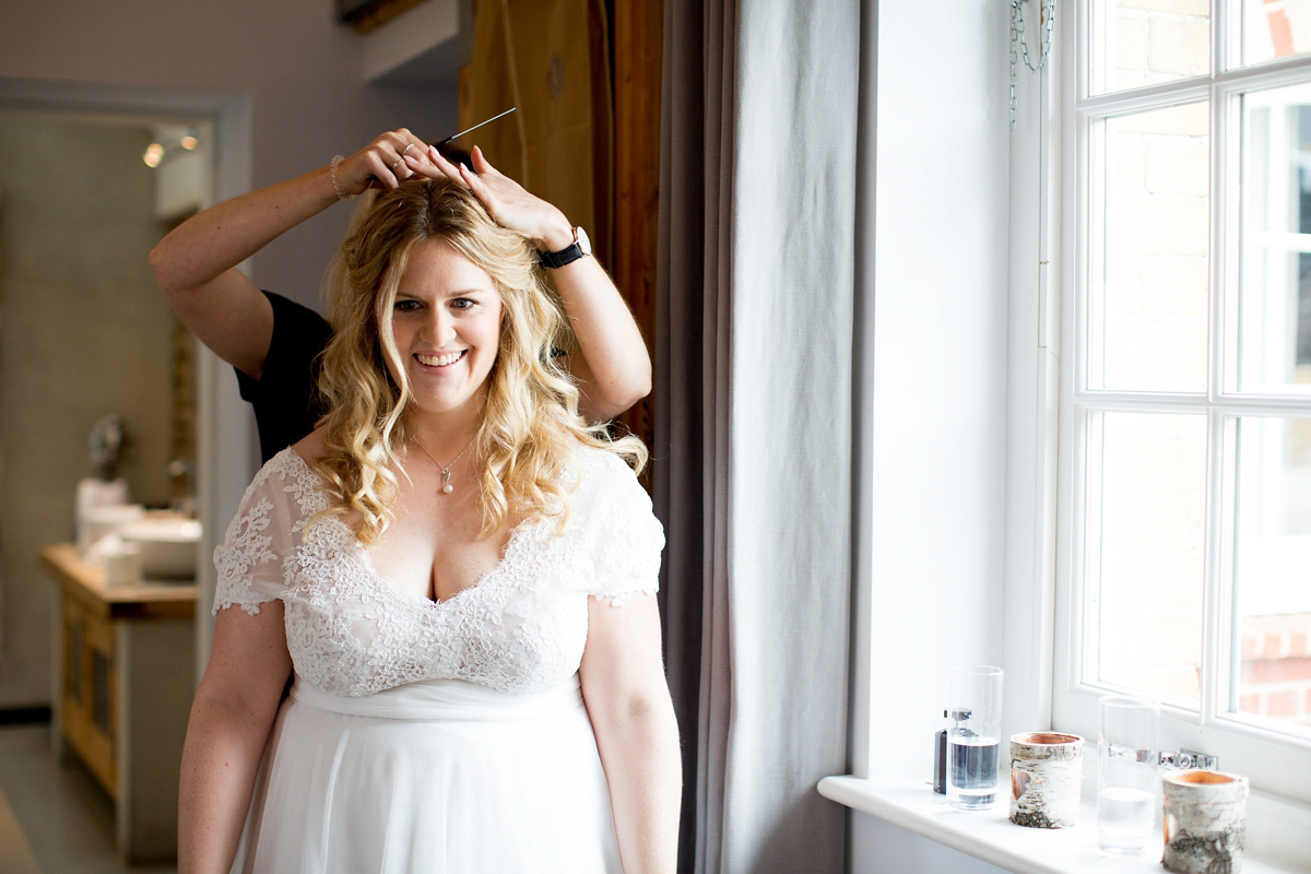 Victoria wore a Cymbeline Paris gown from Mirror Mirror Bridal in Islington for her relaxed and romantic country wedding. The reception was styled like a Green Tavern with long banquet tables. Photography by Helen Cawte.