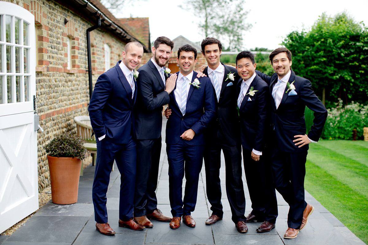 Victoria wore a Cymbeline Paris gown from Mirror Mirror Bridal in Islington for her relaxed and romantic country wedding. The reception was styled like a Green Tavern with long banquet tables. Photography by Helen Cawte.