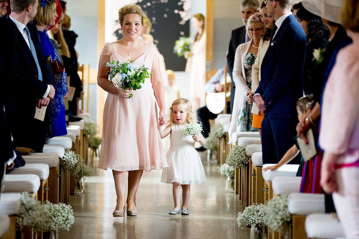 Victoria wore a Cymbeline Paris gown from Mirror Mirror Bridal in Islington for her relaxed and romantic country wedding. The reception was styled like a Green Tavern with long banquet tables. Photography by Helen Cawte.