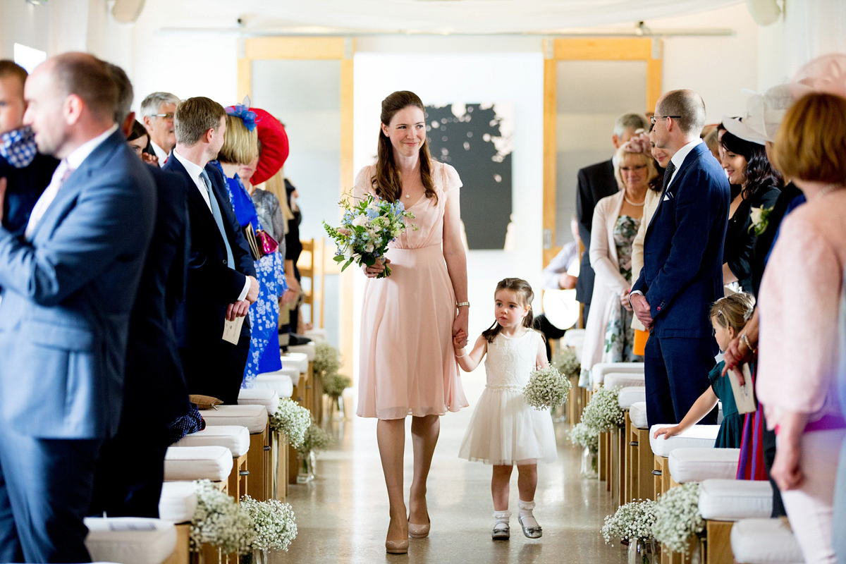 Victoria wore a Cymbeline Paris gown from Mirror Mirror Bridal in Islington for her relaxed and romantic country wedding. The reception was styled like a Green Tavern with long banquet tables. Photography by Helen Cawte.