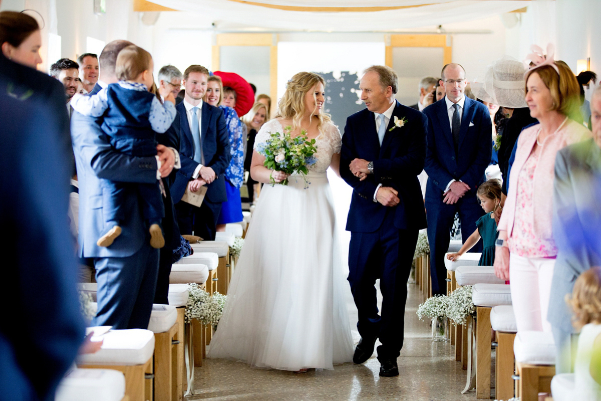 Victoria wore a Cymbeline Paris gown from Mirror Mirror Bridal in Islington for her relaxed and romantic country wedding. The reception was styled like a Green Tavern with long banquet tables. Photography by Helen Cawte.