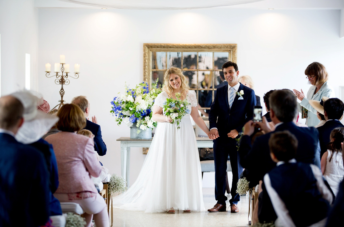 Victoria wore a Cymbeline Paris gown from Mirror Mirror Bridal in Islington for her relaxed and romantic country wedding. The reception was styled like a Green Tavern with long banquet tables. Photography by Helen Cawte.