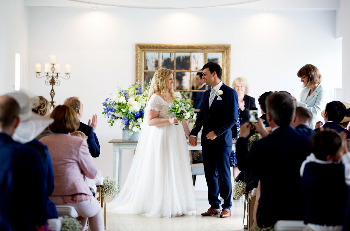 Victoria wore a Cymbeline Paris gown from Mirror Mirror Bridal in Islington for her relaxed and romantic country wedding. The reception was styled like a Green Tavern with long banquet tables. Photography by Helen Cawte.