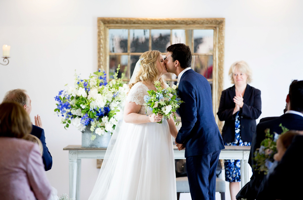 Victoria wore a Cymbeline Paris gown from Mirror Mirror Bridal in Islington for her relaxed and romantic country wedding. The reception was styled like a Green Tavern with long banquet tables. Photography by Helen Cawte.