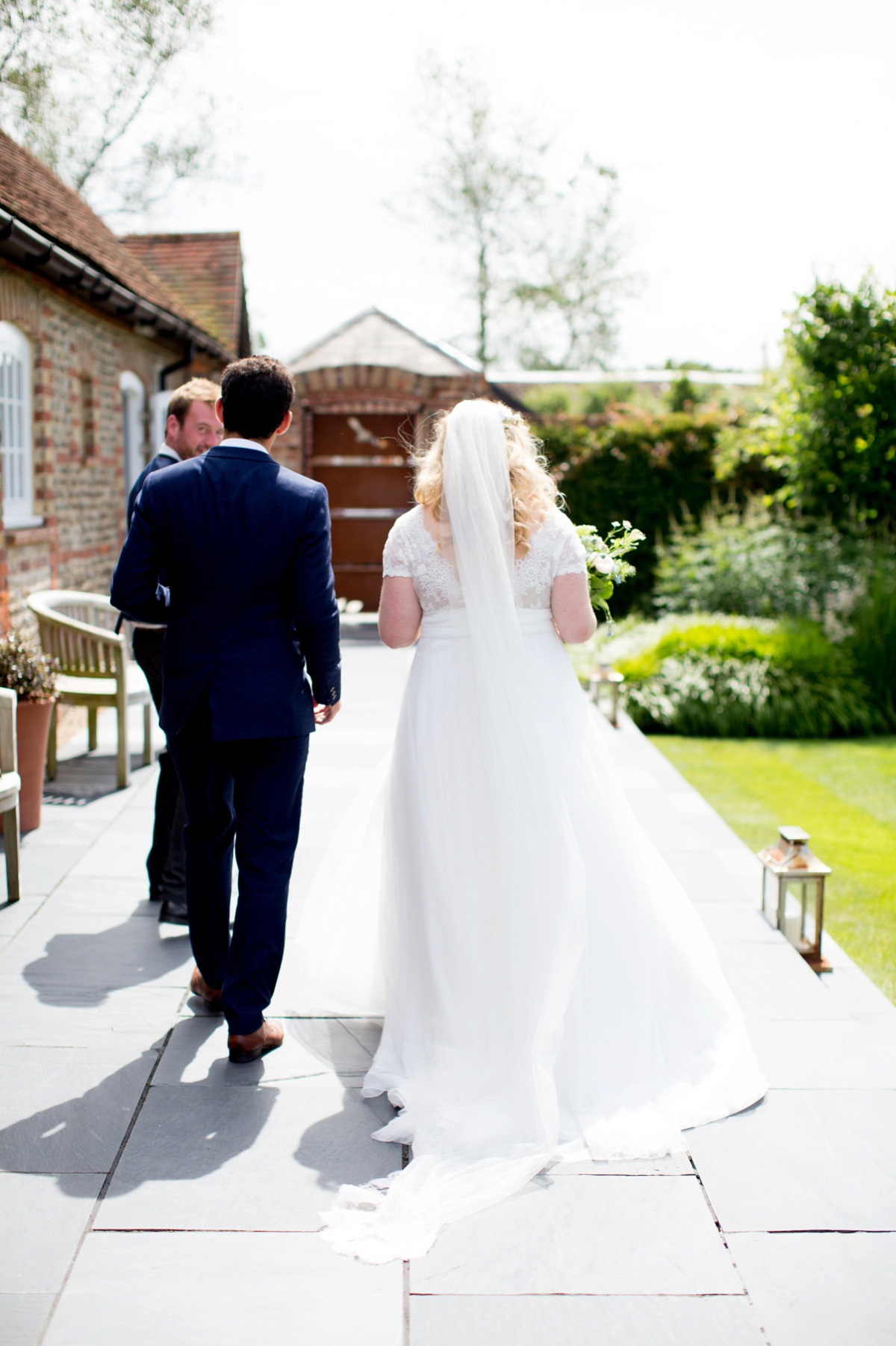 Victoria wore a Cymbeline Paris gown from Mirror Mirror Bridal in Islington for her relaxed and romantic country wedding. The reception was styled like a Green Tavern with long banquet tables. Photography by Helen Cawte.