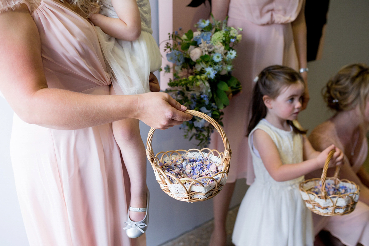 Victoria wore a Cymbeline Paris gown from Mirror Mirror Bridal in Islington for her relaxed and romantic country wedding. The reception was styled like a Green Tavern with long banquet tables. Photography by Helen Cawte.