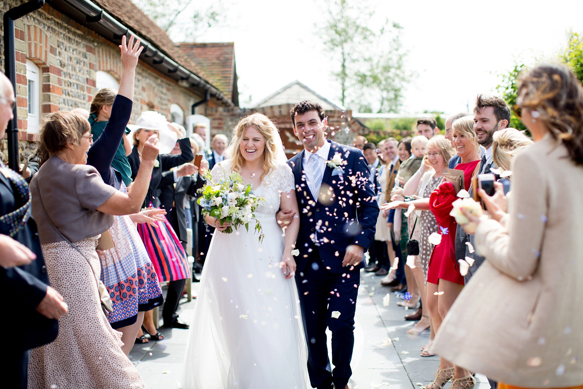 Victoria wore a Cymbeline Paris gown from Mirror Mirror Bridal in Islington for her relaxed and romantic country wedding. The reception was styled like a Green Tavern with long banquet tables. Photography by Helen Cawte.