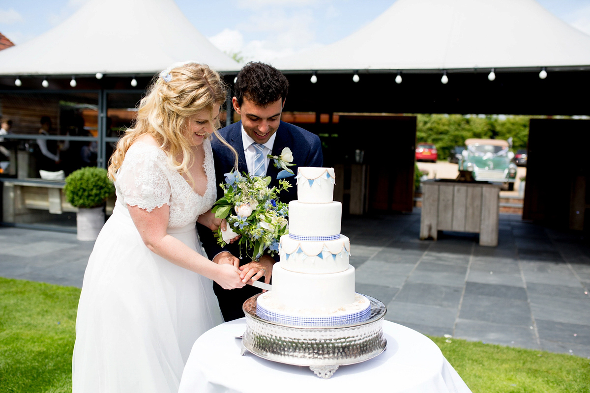 Victoria wore a Cymbeline Paris gown from Mirror Mirror Bridal in Islington for her relaxed and romantic country wedding. The reception was styled like a Green Tavern with long banquet tables. Photography by Helen Cawte.