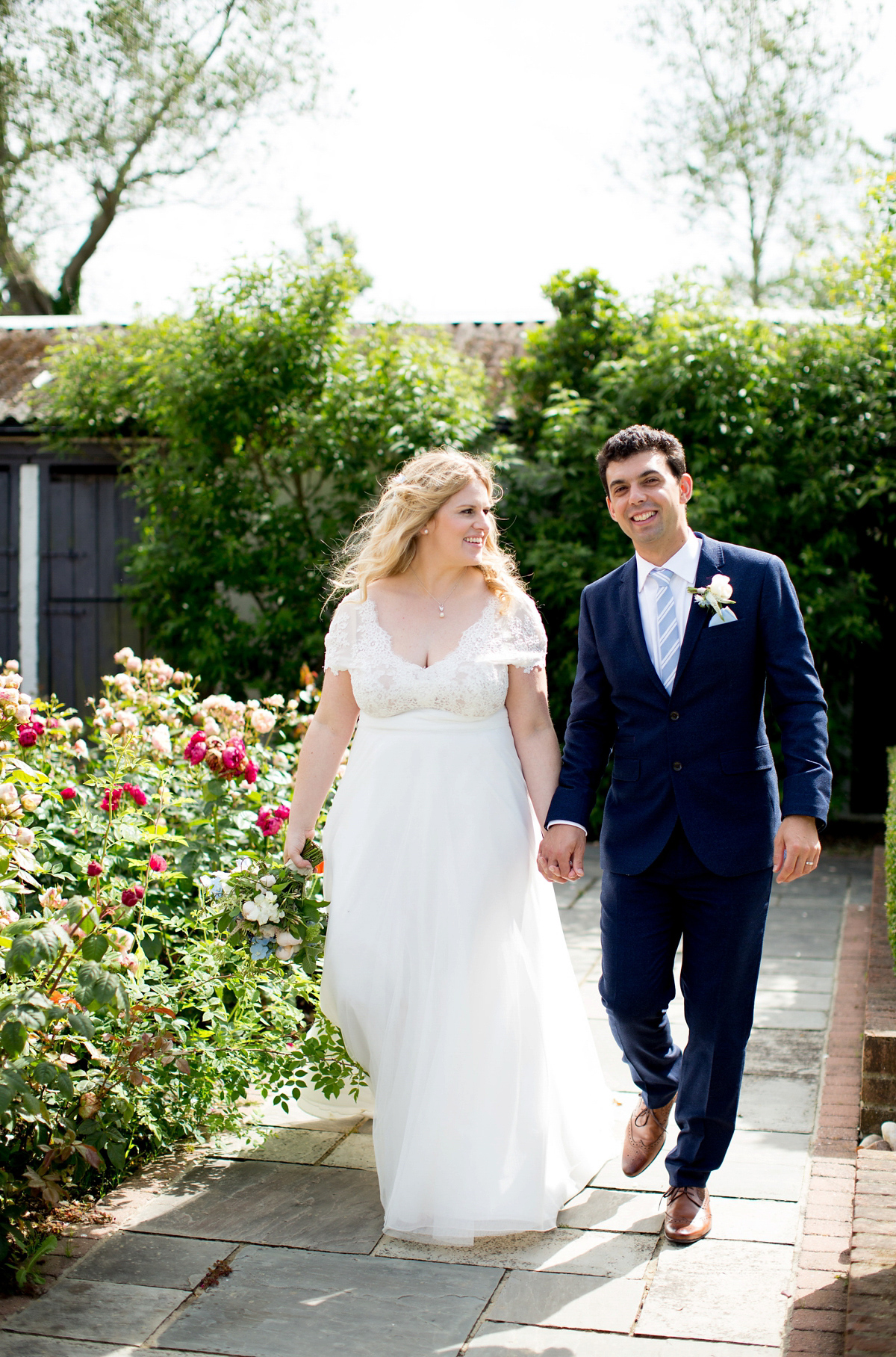 Victoria wore a Cymbeline Paris gown from Mirror Mirror Bridal in Islington for her relaxed and romantic country wedding. The reception was styled like a Green Tavern with long banquet tables. Photography by Helen Cawte.