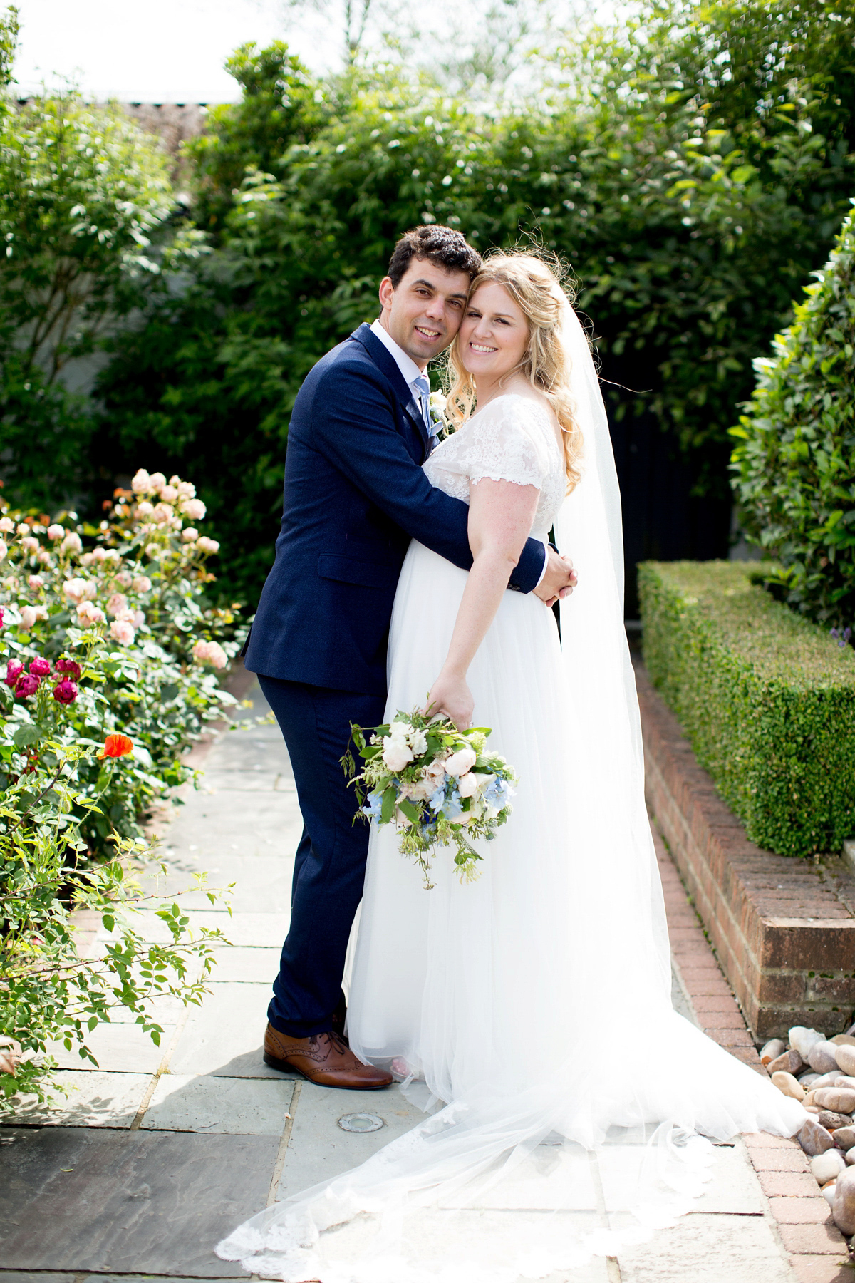 Victoria wore a Cymbeline Paris gown from Mirror Mirror Bridal in Islington for her relaxed and romantic country wedding. The reception was styled like a Green Tavern with long banquet tables. Photography by Helen Cawte.