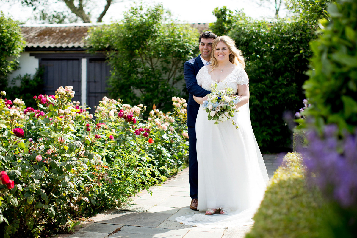 Victoria wore a Cymbeline Paris gown from Mirror Mirror Bridal in Islington for her relaxed and romantic country wedding. The reception was styled like a Green Tavern with long banquet tables. Photography by Helen Cawte.