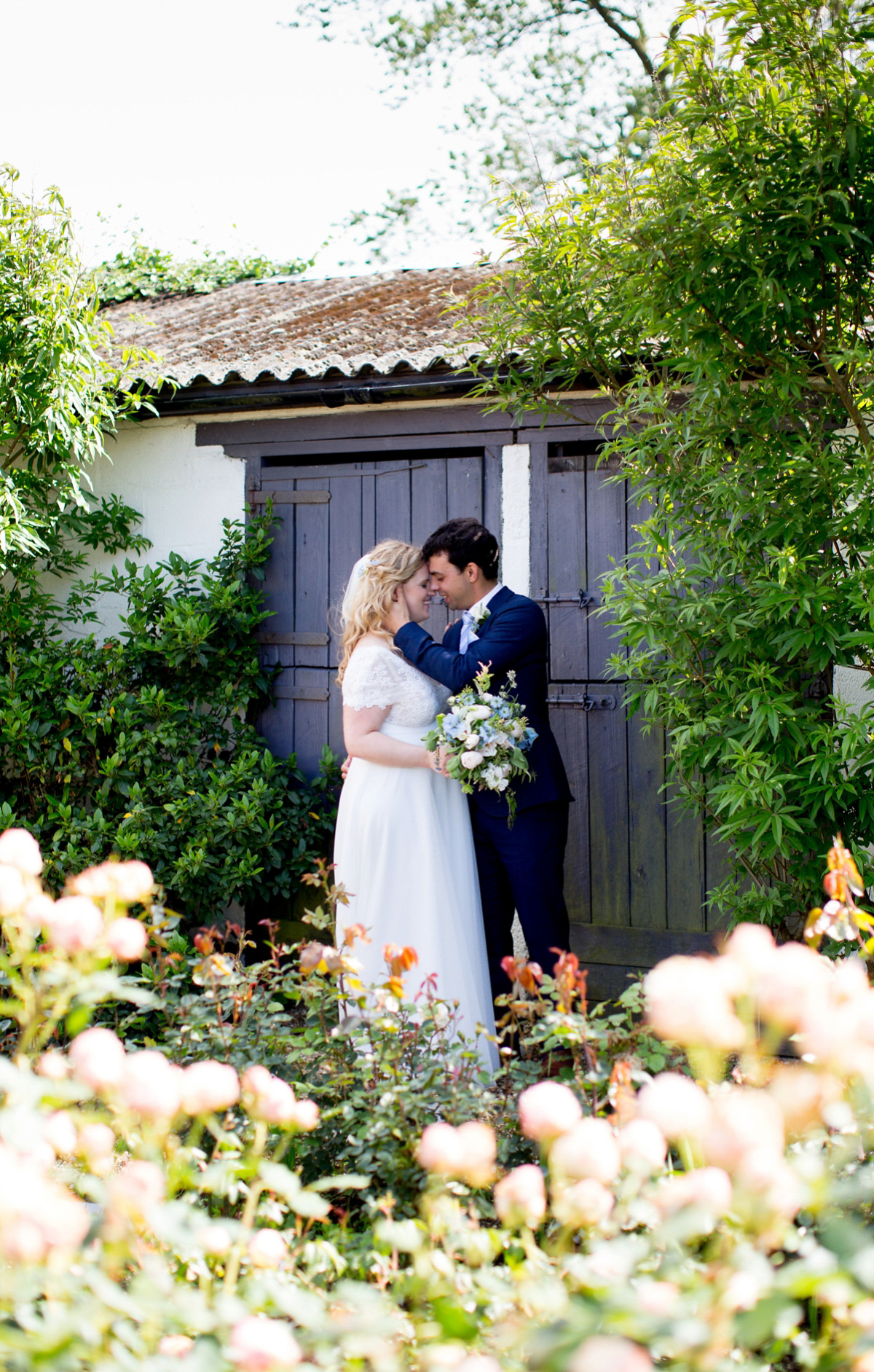 Victoria wore a Cymbeline Paris gown from Mirror Mirror Bridal in Islington for her relaxed and romantic country wedding. The reception was styled like a Green Tavern with long banquet tables. Photography by Helen Cawte.