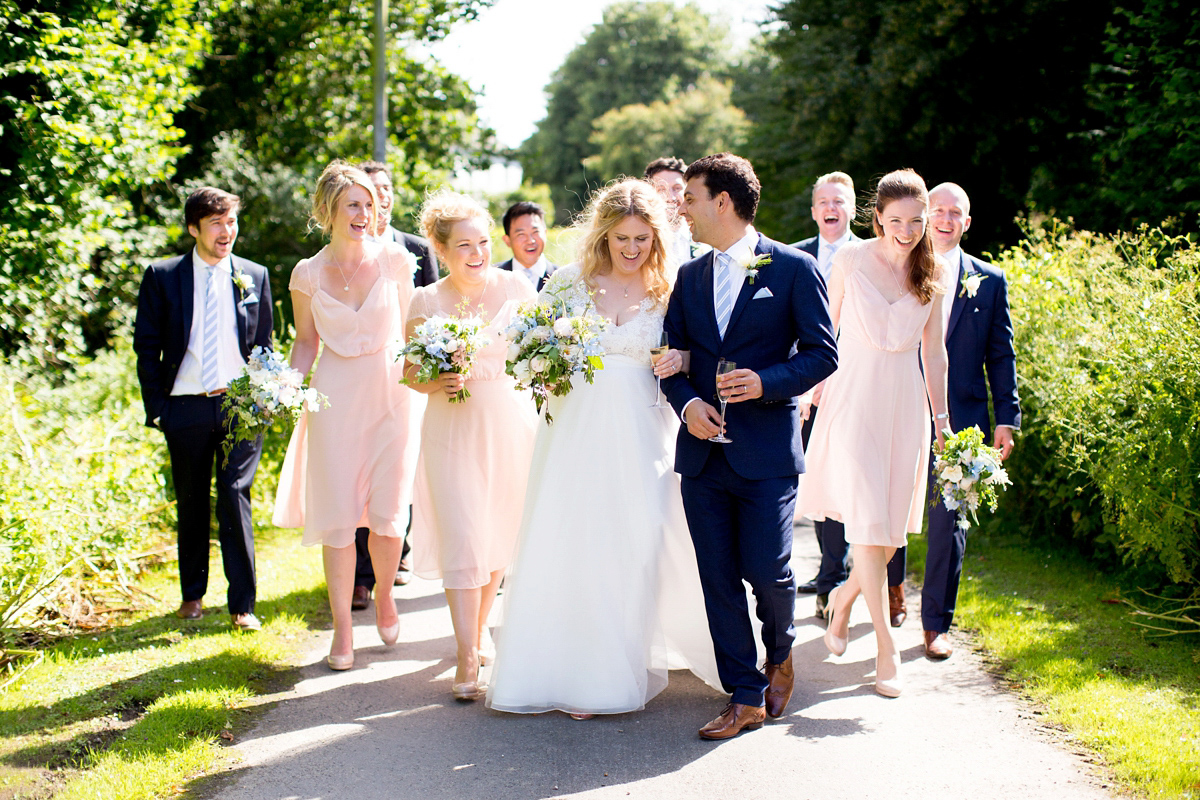 Victoria wore a Cymbeline Paris gown from Mirror Mirror Bridal in Islington for her relaxed and romantic country wedding. The reception was styled like a Green Tavern with long banquet tables. Photography by Helen Cawte.