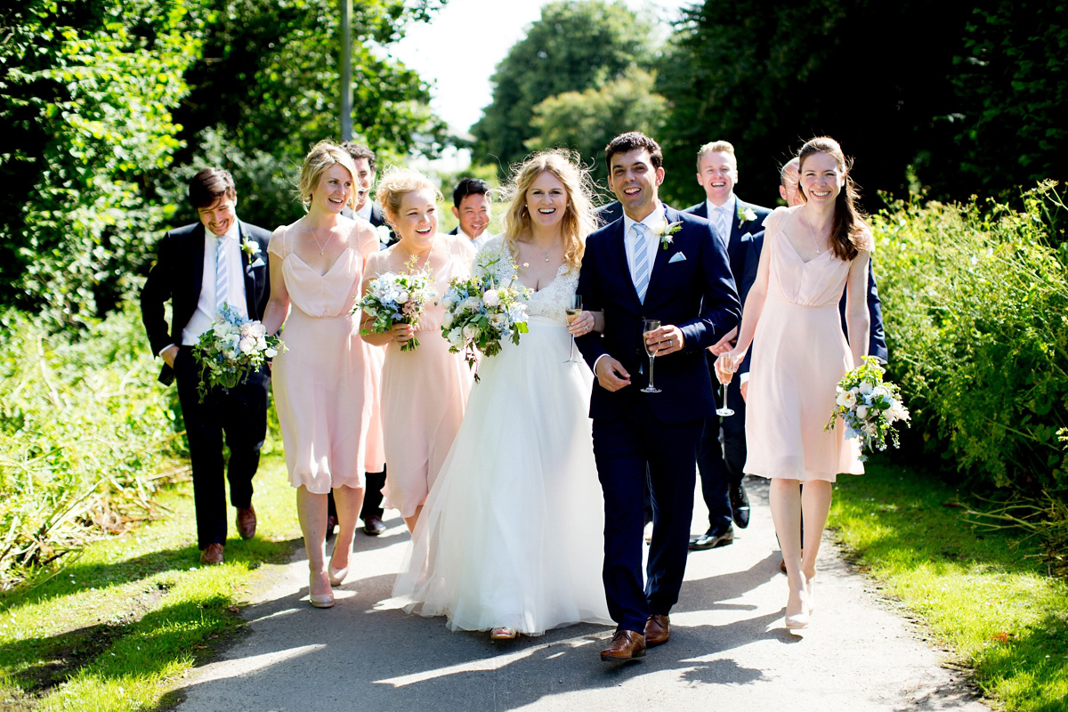 Victoria wore a Cymbeline Paris gown from Mirror Mirror Bridal in Islington for her relaxed and romantic country wedding. The reception was styled like a Green Tavern with long banquet tables. Photography by Helen Cawte.