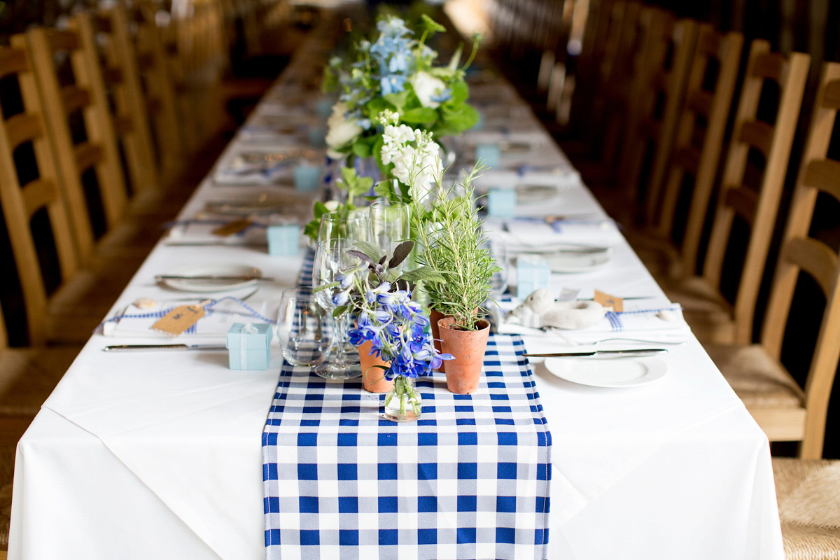 Victoria wore a Cymbeline Paris gown from Mirror Mirror Bridal in Islington for her relaxed and romantic country wedding. The reception was styled like a Green Tavern with long banquet tables. Photography by Helen Cawte.