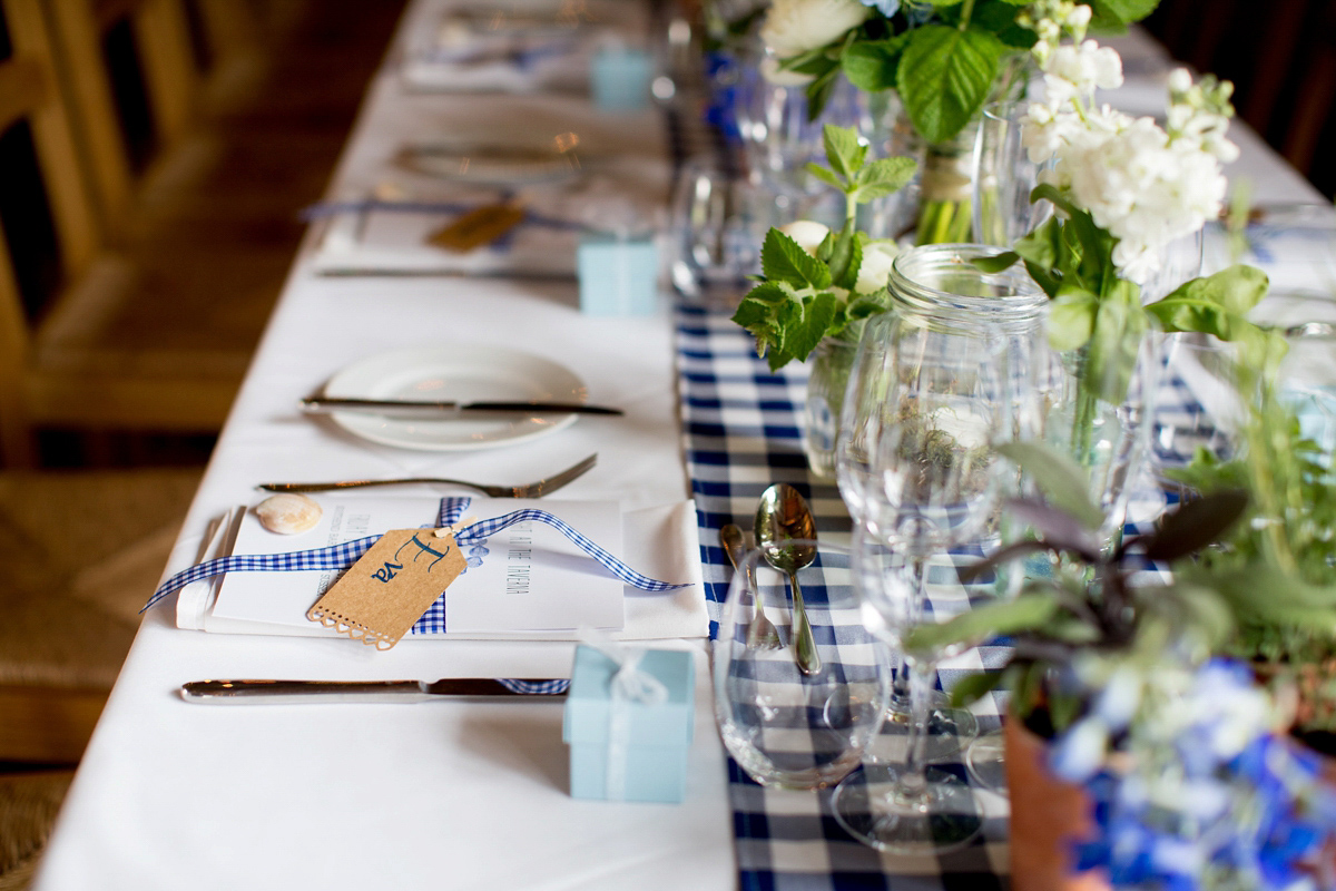 Victoria wore a Cymbeline Paris gown from Mirror Mirror Bridal in Islington for her relaxed and romantic country wedding. The reception was styled like a Green Tavern with long banquet tables. Photography by Helen Cawte.