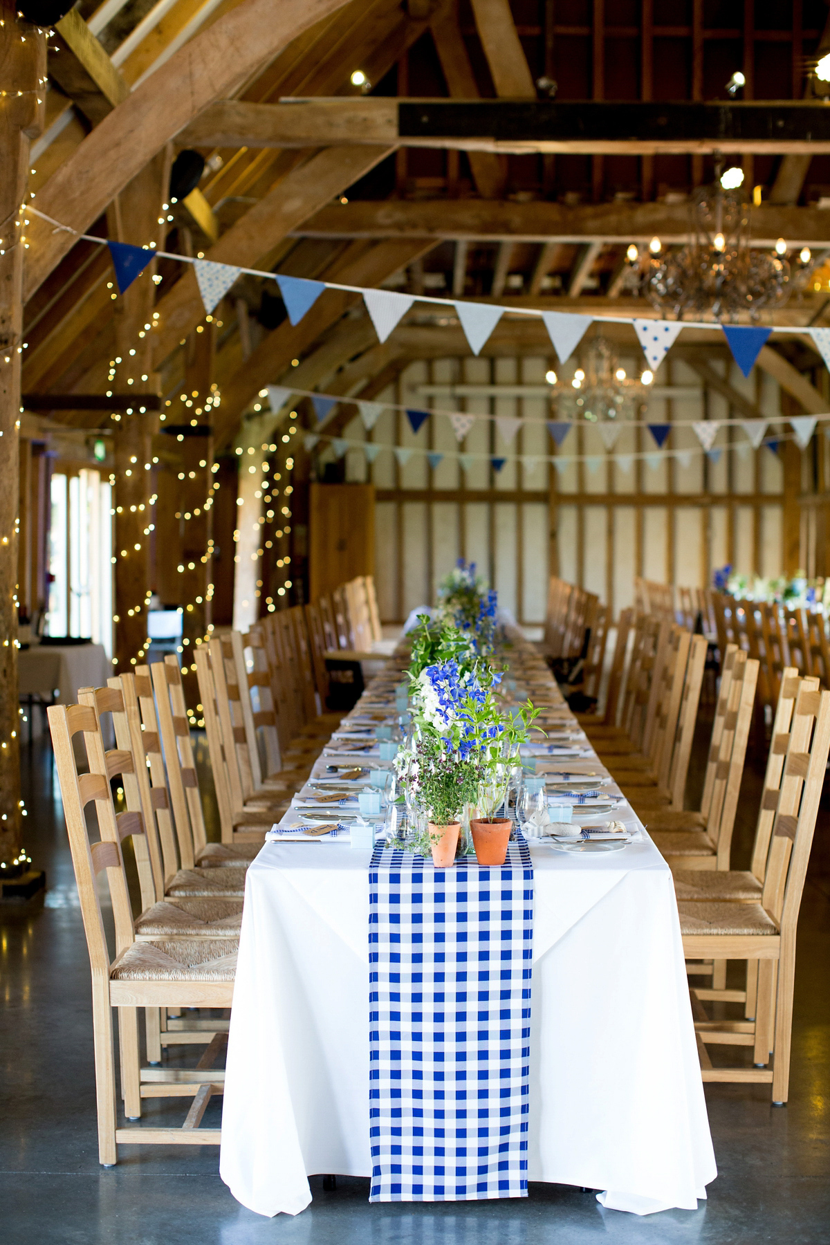 Victoria wore a Cymbeline Paris gown from Mirror Mirror Bridal in Islington for her relaxed and romantic country wedding. The reception was styled like a Green Tavern with long banquet tables. Photography by Helen Cawte.