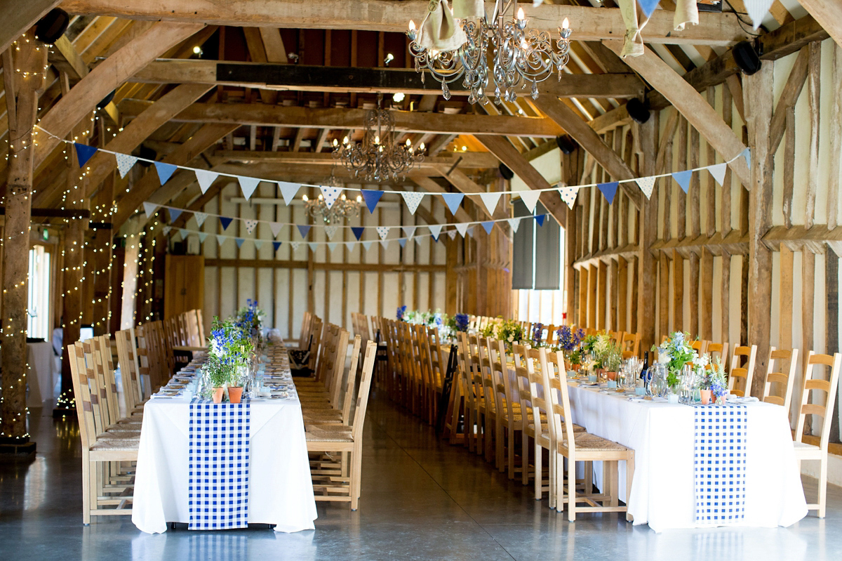 Victoria wore a Cymbeline Paris gown from Mirror Mirror Bridal in Islington for her relaxed and romantic country wedding. The reception was styled like a Green Tavern with long banquet tables. Photography by Helen Cawte.