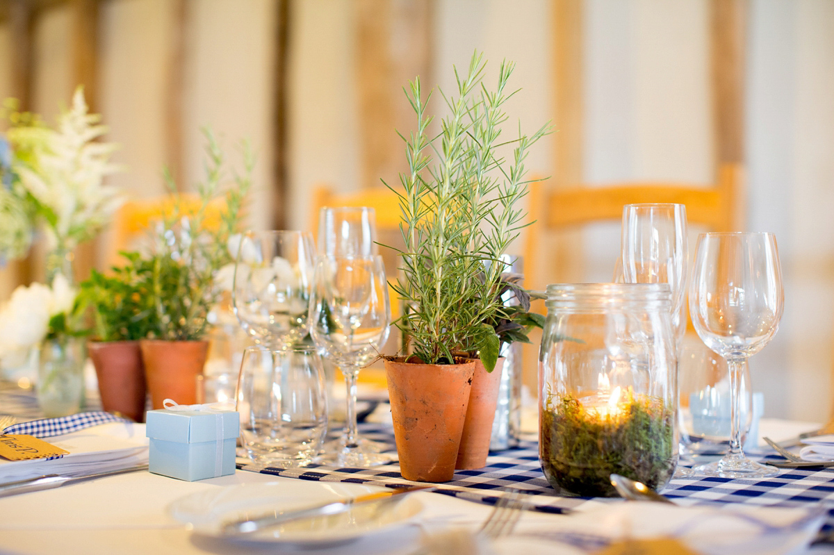 Victoria wore a Cymbeline Paris gown from Mirror Mirror Bridal in Islington for her relaxed and romantic country wedding. The reception was styled like a Green Tavern with long banquet tables. Photography by Helen Cawte.