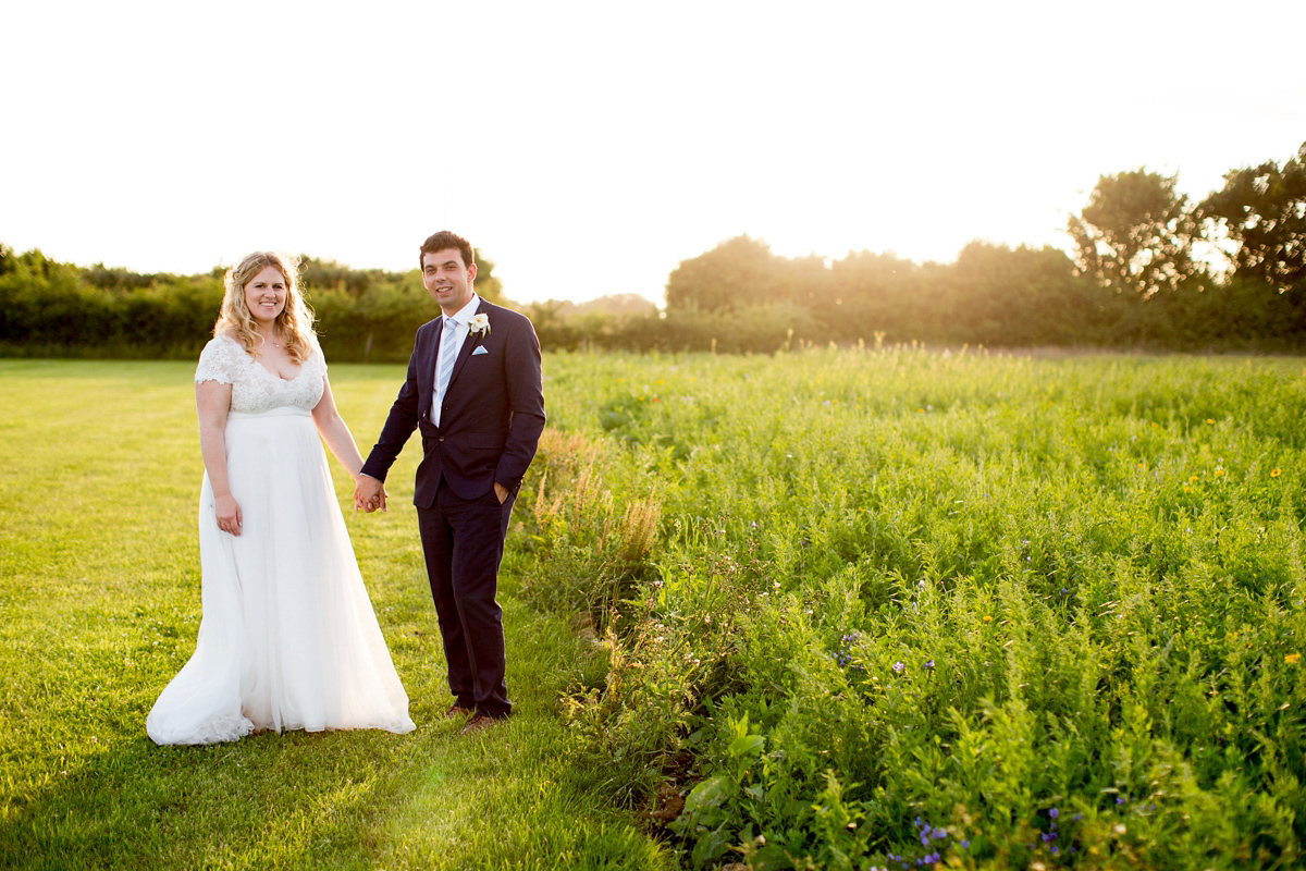 Victoria wore a Cymbeline Paris gown from Mirror Mirror Bridal in Islington for her relaxed and romantic country wedding. The reception was styled like a Green Tavern with long banquet tables. Photography by Helen Cawte.