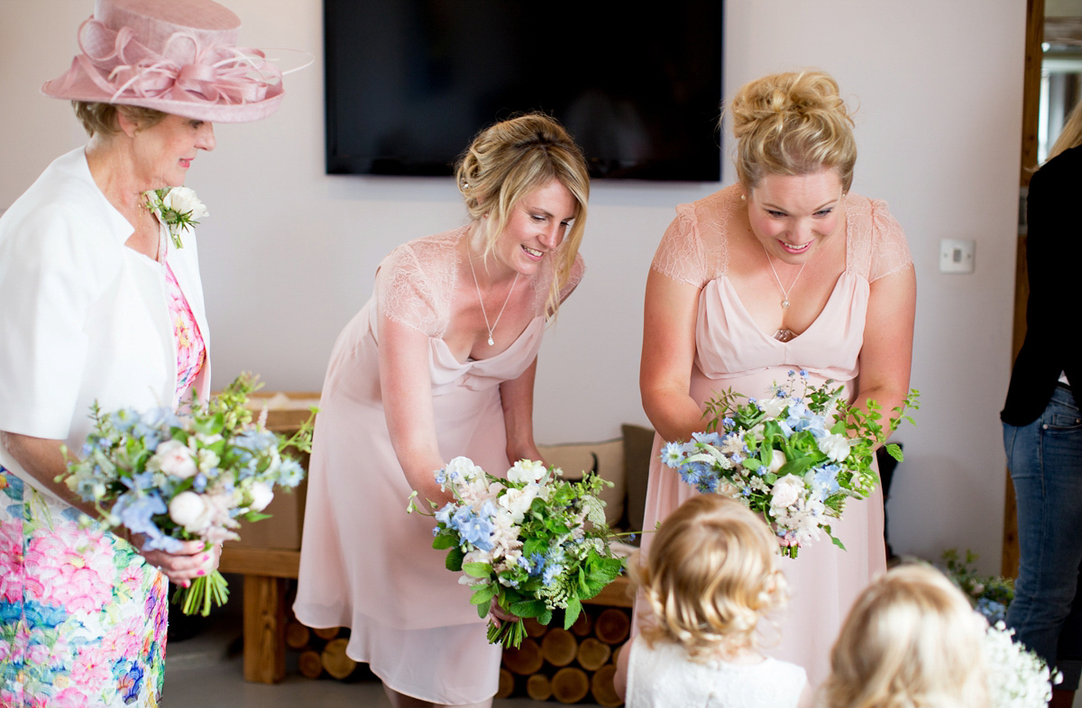 Victoria wore a Cymbeline Paris gown from Mirror Mirror Bridal in Islington for her relaxed and romantic country wedding. The reception was styled like a Green Tavern with long banquet tables. Photography by Helen Cawte.