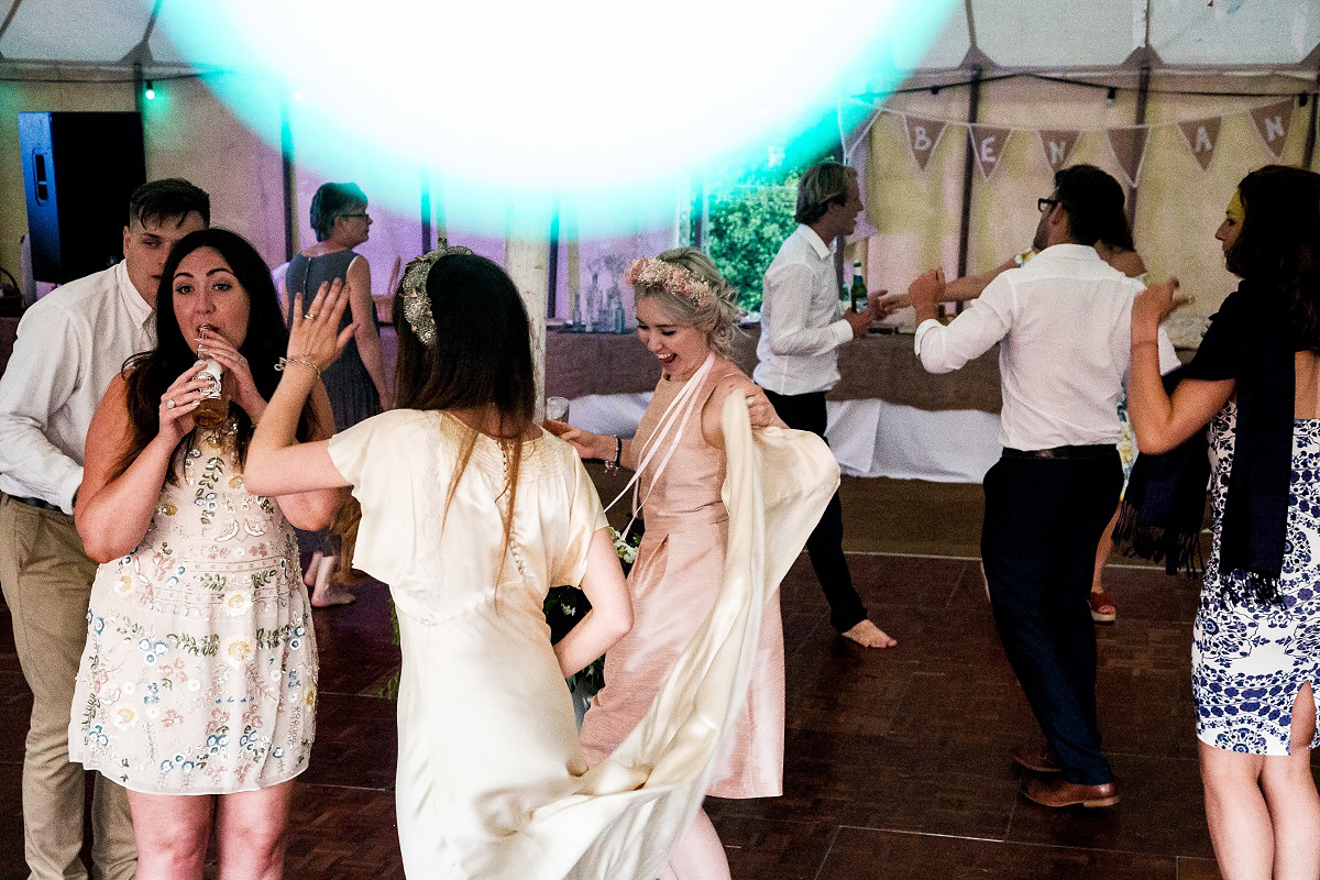 Layla wore a 1930's vintage dress for her summer country marquee wedding. Photography by Hannah Betts.