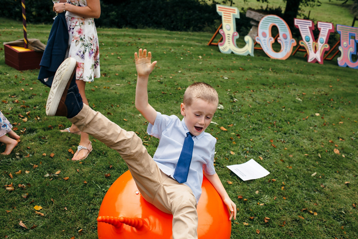 Emily wore a Needle & Thread dress for her colourful, balloon and glitter filled wedding at Coombe Trenchard. Images by Freckle Photography.