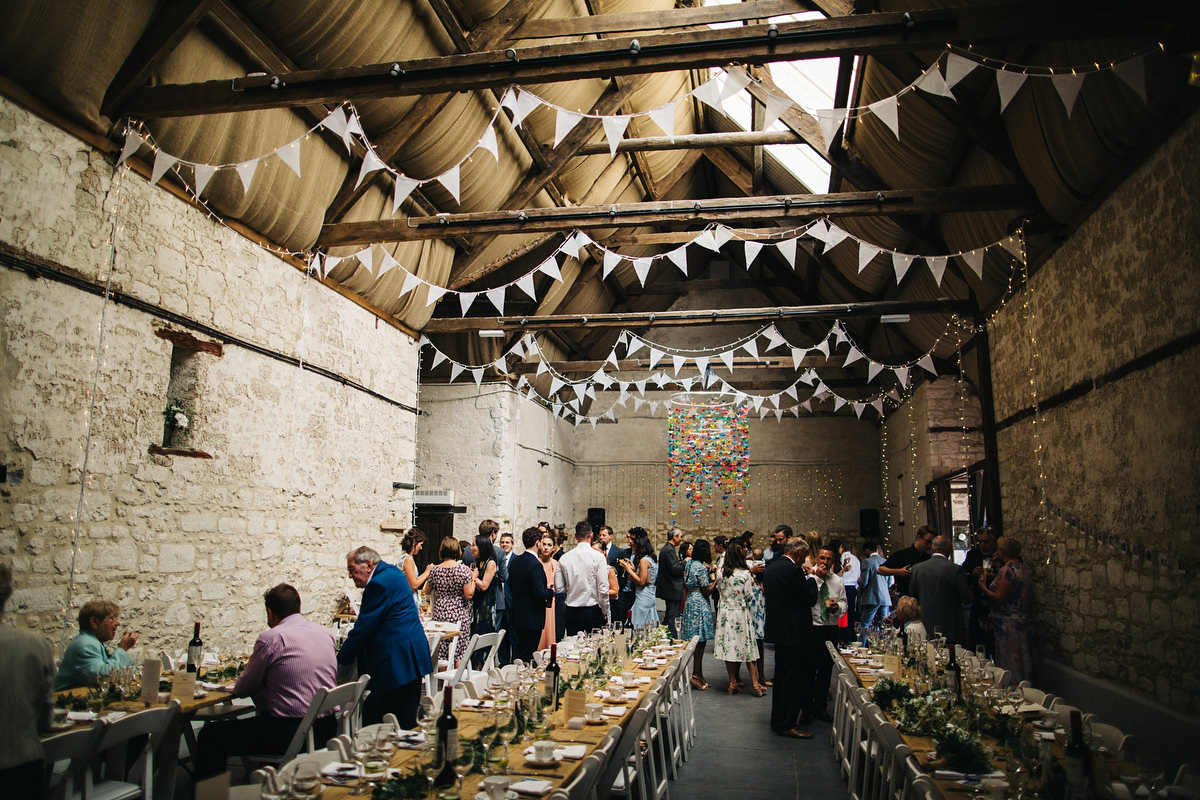 Sarah wore a Grace Loves Lace dress for her rustic Dorset barn wedding with paper cranes. Photography by Richard Skins.