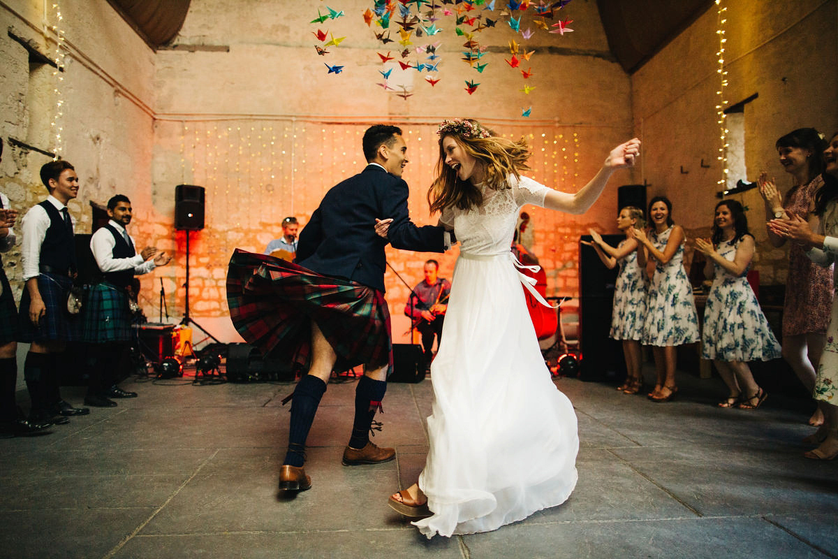 Sarah wore a Grace Loves Lace dress for her rustic Dorset barn wedding with paper cranes. Photography by Richard Skins.