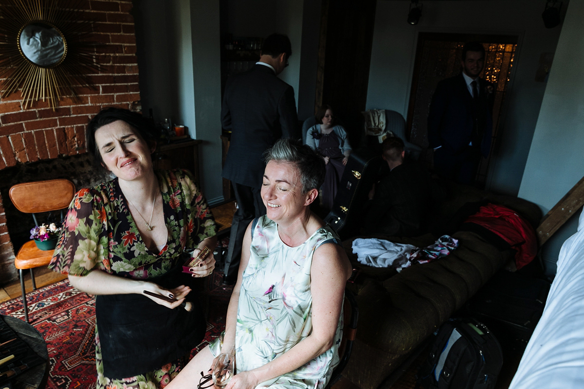 Emma and Marshy had a secret wedding in Brighton. Emma wore a bespoke blue dress by Suzanne Neville. Photography by Nick Tucker.