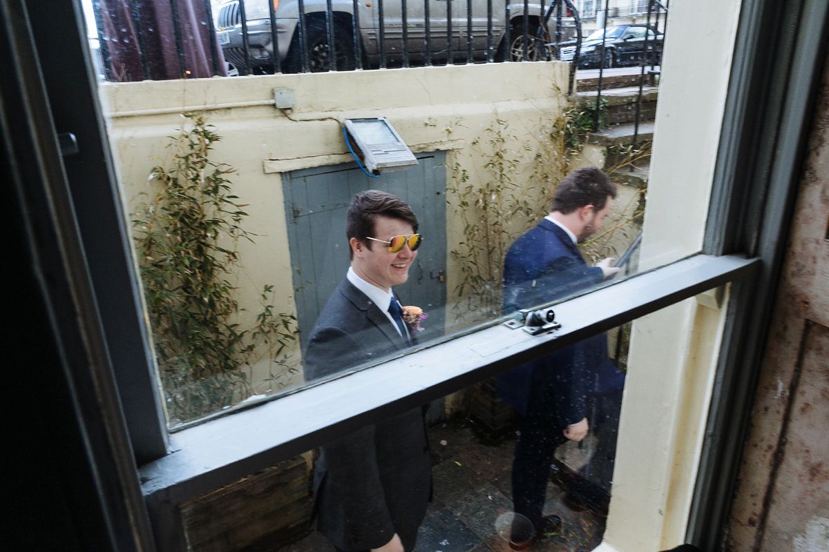 Emma and Marshy had a secret wedding in Brighton. Emma wore a bespoke blue dress by Suzanne Neville. Photography by Nick Tucker.