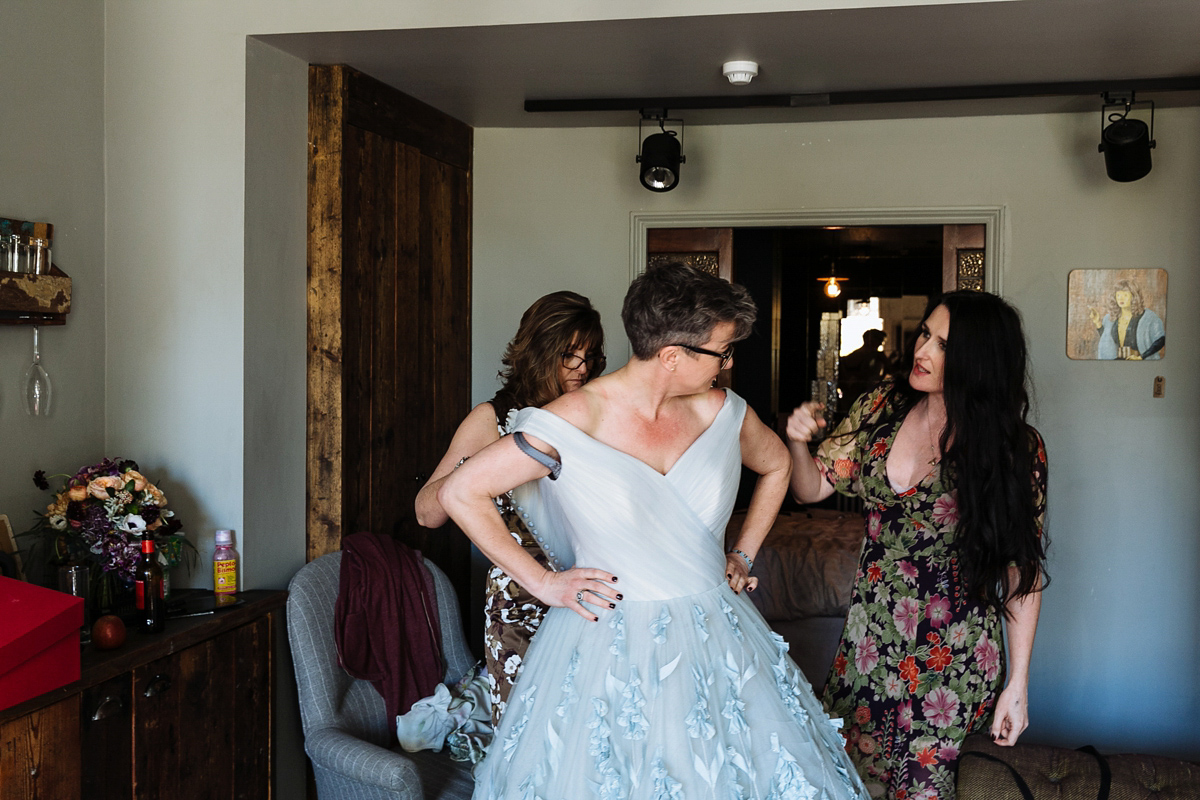 Emma and Marshy had a secret wedding in Brighton. Emma wore a bespoke blue dress by Suzanne Neville. Photography by Nick Tucker.