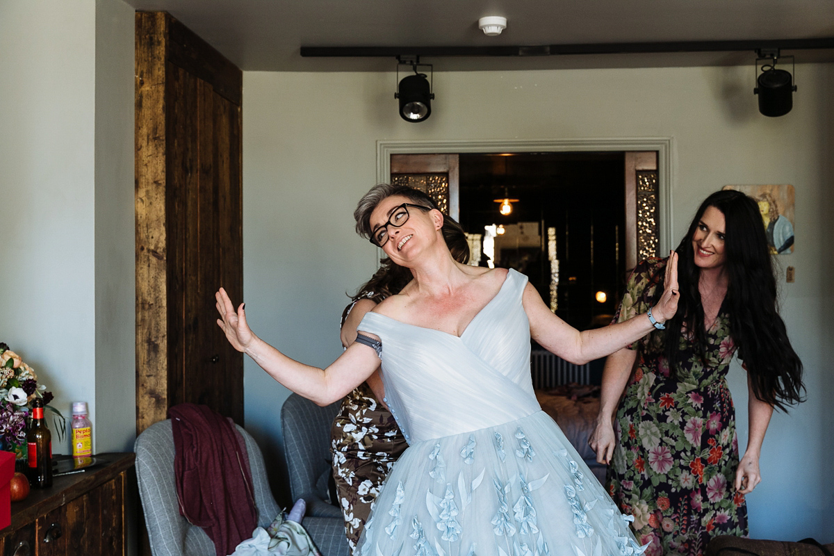 Emma and Marshy had a secret wedding in Brighton. Emma wore a bespoke blue dress by Suzanne Neville. Photography by Nick Tucker.