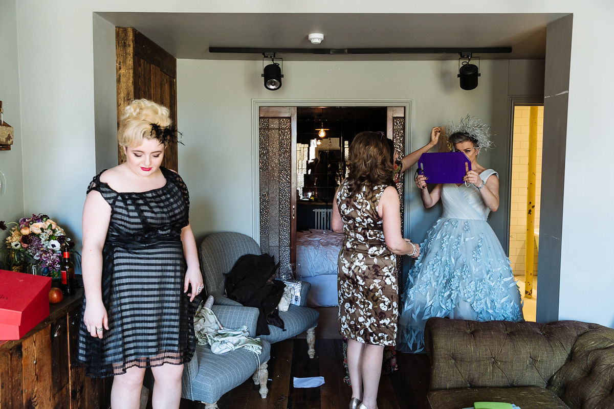 Emma and Marshy had a secret wedding in Brighton. Emma wore a bespoke blue dress by Suzanne Neville. Photography by Nick Tucker.