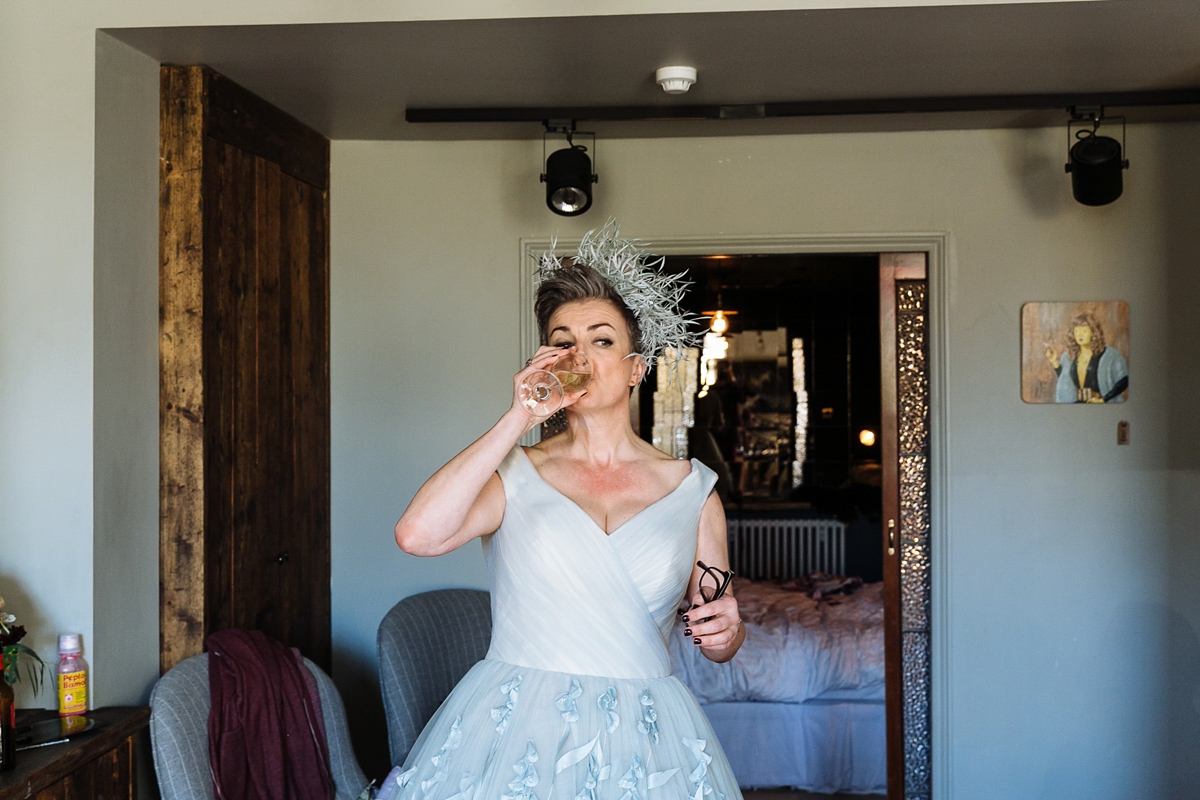 Emma and Marshy had a secret wedding in Brighton. Emma wore a bespoke blue dress by Suzanne Neville. Photography by Nick Tucker.