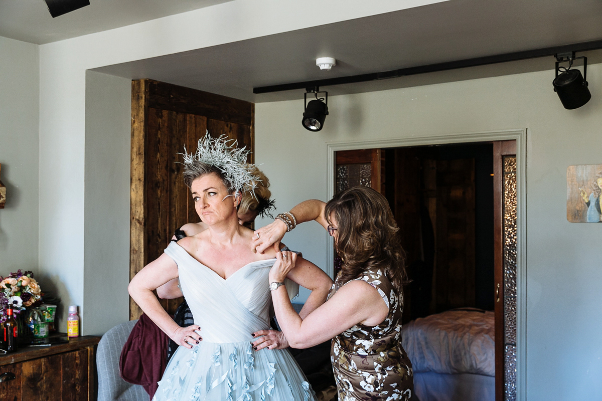 Emma and Marshy had a secret wedding in Brighton. Emma wore a bespoke blue dress by Suzanne Neville. Photography by Nick Tucker.