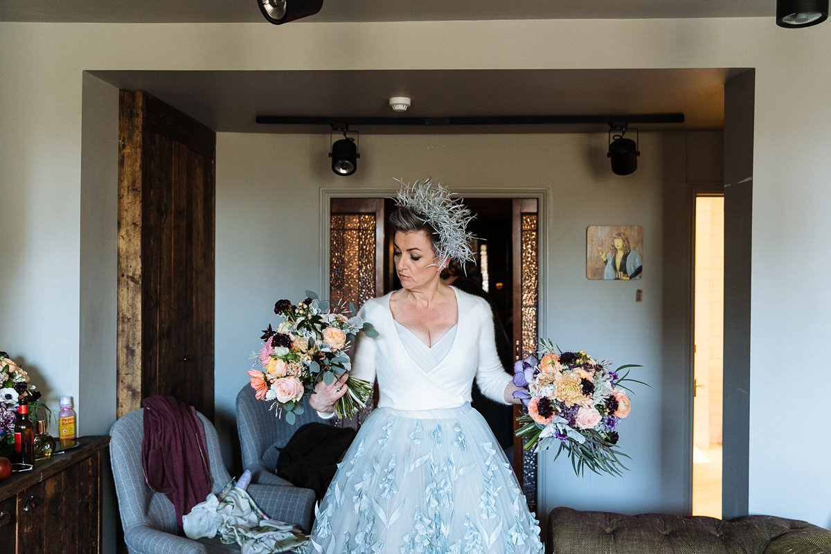 Emma and Marshy had a secret wedding in Brighton. Emma wore a bespoke blue dress by Suzanne Neville. Photography by Nick Tucker.