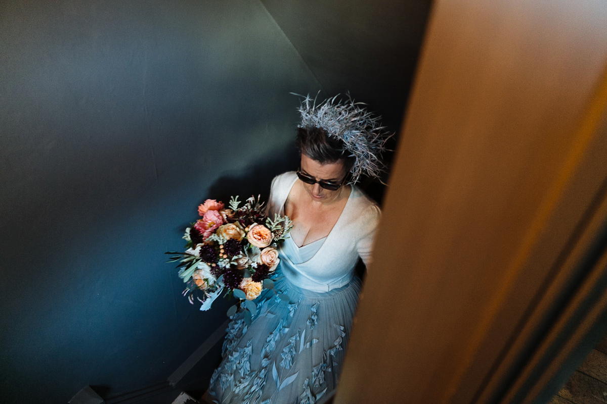 Emma and Marshy had a secret wedding in Brighton. Emma wore a bespoke blue dress by Suzanne Neville. Photography by Nick Tucker.