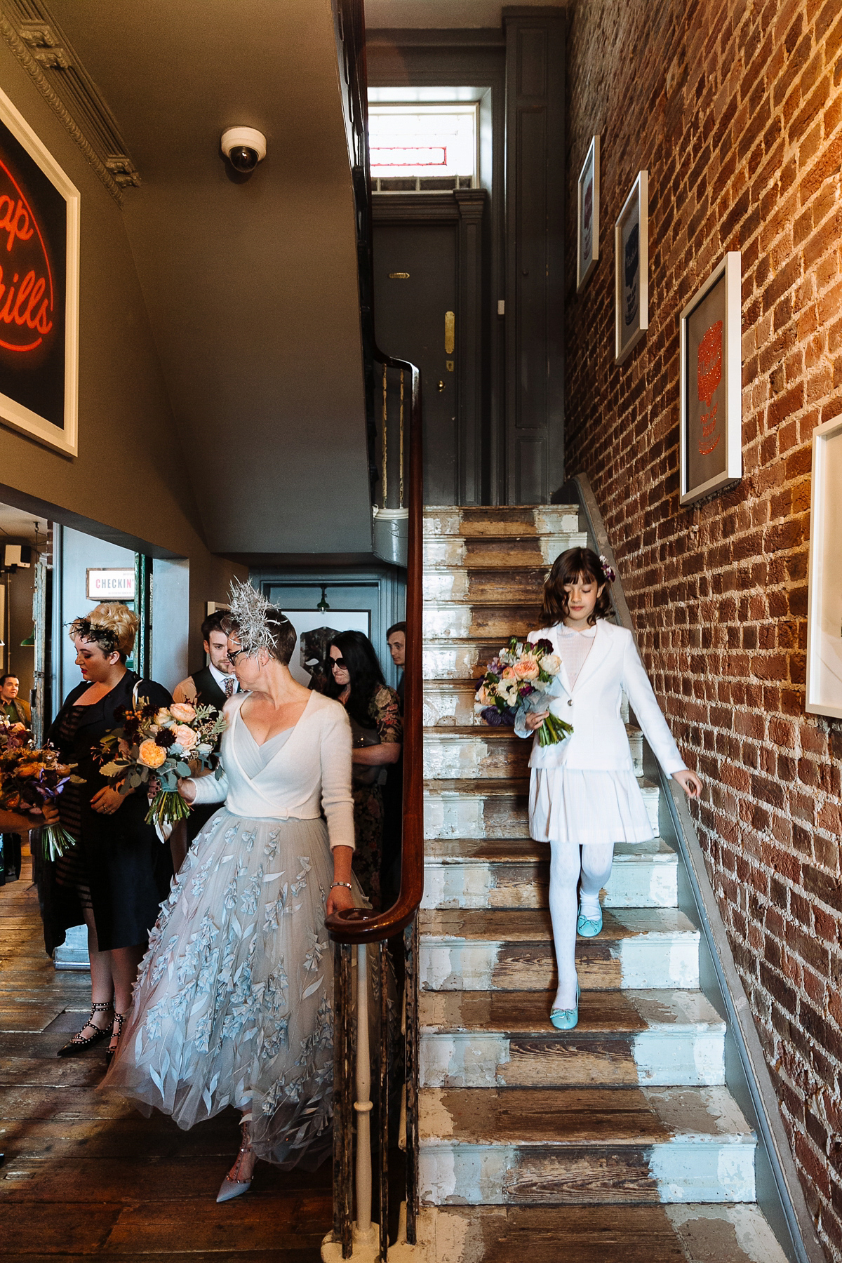 Emma and Marshy had a secret wedding in Brighton. Emma wore a bespoke blue dress by Suzanne Neville. Photography by Nick Tucker.